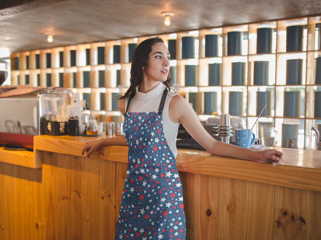 girl-wearing-an-apron-mockup-relaxing-at-a-tea-bar